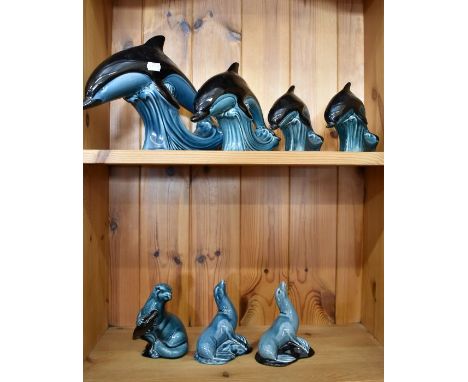 Four Poole pottery two-tone dolphins to/w three Poole pottery sea lions (7)