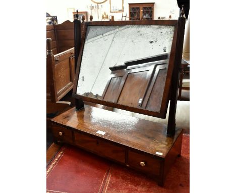 A 19th century mahogany toilet mirror with bevelled rectangular plate supported by pair of reeded columns with brass finials 