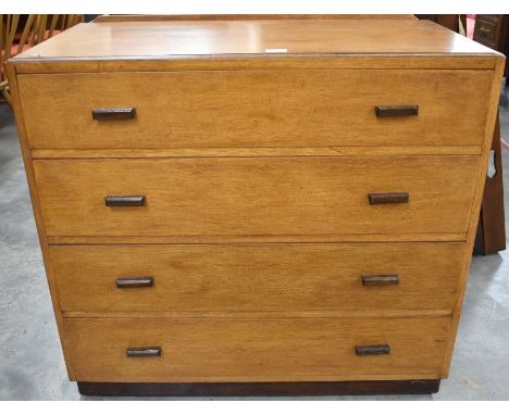 A 1950s G-plan style light oak chest of four long drawers, stained moulded handles and plinth base, 92 cm wide x 48 cm dep x 