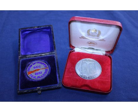 A 1887 silver crown with enamel decoration to the front along with a cased Stonehenge silver jubilee coin 