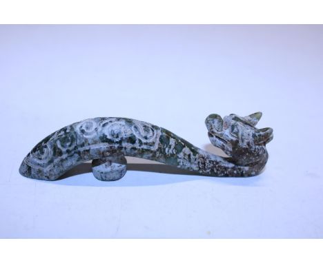 A antique Chinese green jade belt hook in the form of a dragon 