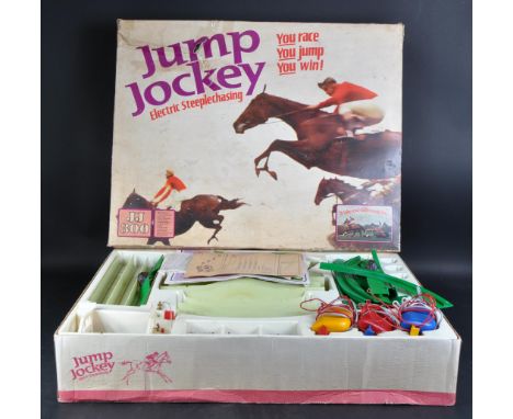 An original vintage Triang JJ300 Jump Jockey electronic table top horse racing set. The set containing x3 horses, x3 controll