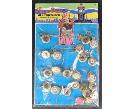 A vintage ex-shop stock display of x23 gold coloured plastic ' Grandads Old Time Watches '. The pocket watches with black and