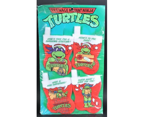 A collection of vintage 1990 Mirage Studios TMNT Teenage Mutant Ninja Turtles Christmas stockings. Each felt stocking measuri