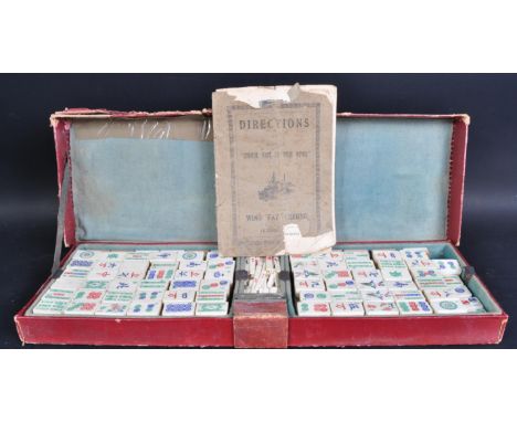 A 20th Century vintage Chinese Mahjong set ' Chinese Game Of Four Winds '. The set containing bone tiles with Chinese charact