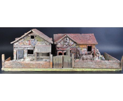 An early 20th Century / pre-war German Elastolin made model farm compound diorama with various buildings and farm animals. Th