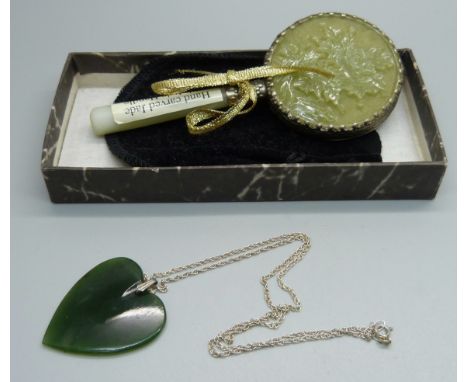 A jade pendant on chain and a jade mirror 
