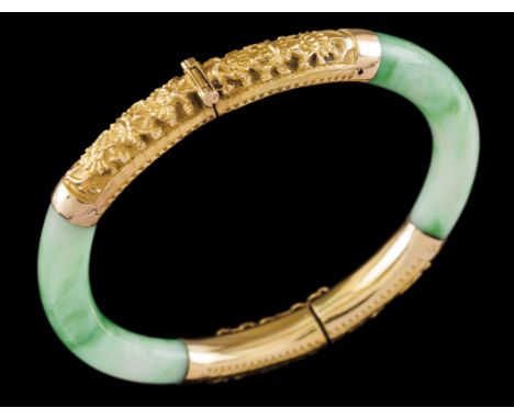 A braceletGold and jadeHinged jade elements of applied gold details with raised oriental motifs decorationHong-Kong, ca. 1950