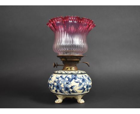 A Ceramic Based Oil Lamp with Nice Quality Ribbed and Reeded Cranberry Glass Shade, 33cm high 