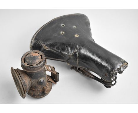 A Vintage Bicycle Saddle and Carbide Bicycle Lamp 