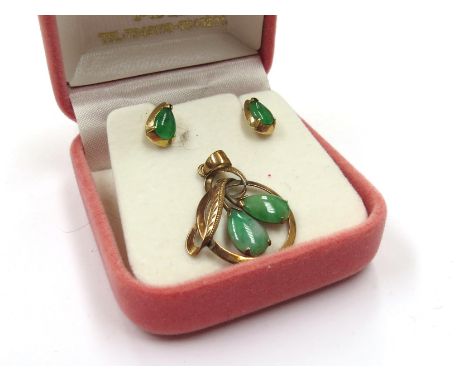 A gold pendant with two pear shaped jade cabochons stamped 14k and a pair of similar earrings