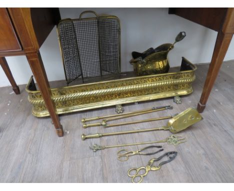 A quantity of brass fireside items consisting of fire screen, fender, fire tools and a coal scuttle