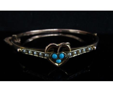 A 9ct gold bangle with heart motif set with turquoise and flanked by a row of pearls, 6cm x 5cm, 6g