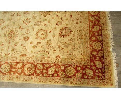 A gold and terracotta wool carpet with all-over foliate pattern, 306cm x 237cm