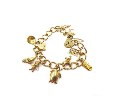 A 9ct gold charm bracelet hung with various charms including seal, abacus, turtle, dog etc, 35.4g