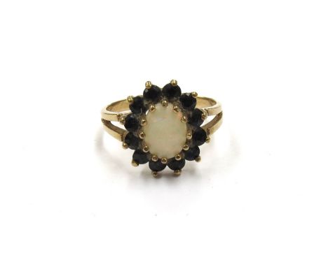 A 9ct gold opal and sapphire cluster ring. Size P, 2.5g