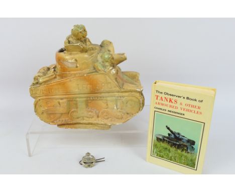 A ceramic model depicting a stylised French tank, a white metal Royal Tank Regiment cap badge and an Observer's Book Of Tanks