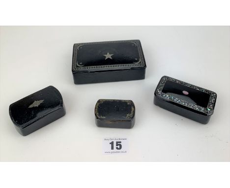 4 snuff boxes including inlaid and mother of pearl.  Sun and moon box 4.5" wide. Smallest 2" wide