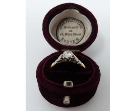 A vintage 18 carat yellow gold and platinum solitaire ring in a velvet antique ring box. Set with a round brilliant cut diamo