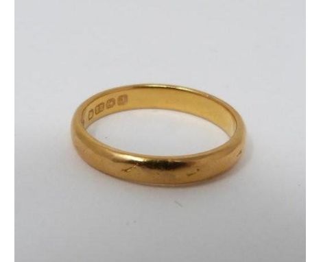 An Art Deco 22 carat yellow gold engraved D-shaped wedding band. Hallmarked BlBs for Bendall Brothers, Birmingham 1933. Weigh