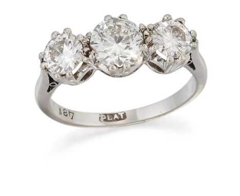 A DIAMOND THREE STONE RING, graduated round brilliant-cut diamonds in double-claw settings, to tapering shoulders, total esti