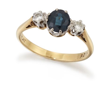 A SAPPHIRE AND DIAMOND THREE-STONE RING, a round-cut sapphire in a claw setting, spaced by round brilliant-cut diamonds, to f