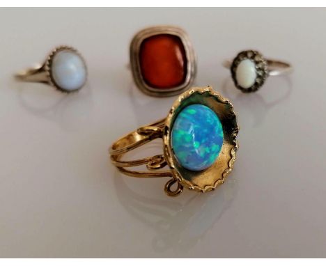 A yellow gold opal ring in the Grecian style, size P, stamped 9kt, 4.2g and three silver gem-set rings, all hallmarked, sizes