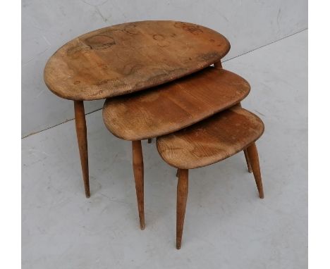 A nest of 3 Ercol elm and beech pebble occasional tables, middle table cracked, all with stains