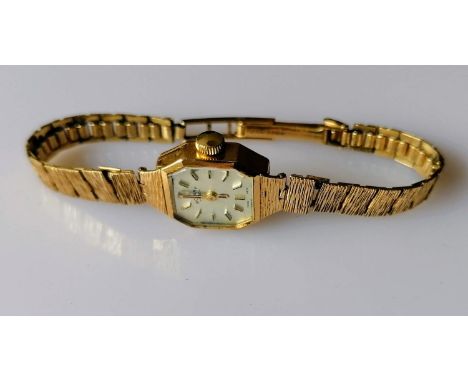 A mid-century ladies Rotary manual dress watch with baton markers, hallmarked 9ct gold case and strap, in working order, net 