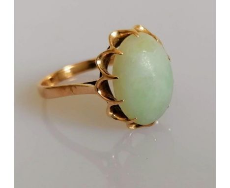 A 9ct yellow gold ring with an oval jade cabochon 15mm x 12mm) in a claw setting, size S, marks rubbed, 4.16g