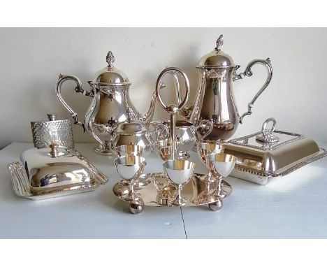 An assortment of silver plate to include a four-piece tea and coffee service, two food warmers, an egg cruet and a hip flask 