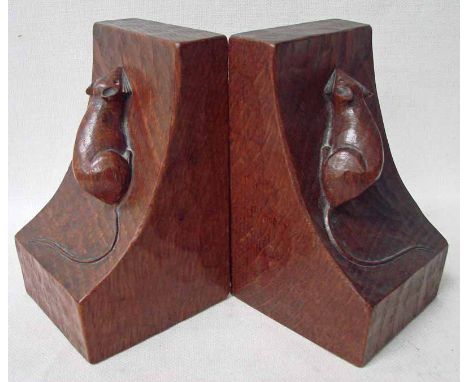 A pair of adzed oak bookends by Robert 'Mouseman' Thompson of Kilburn, of typical form with carved trademark mouse to each sl