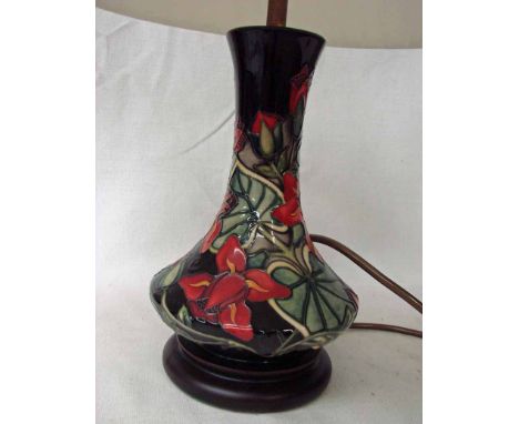 A modern Moorcroft pottery table lamp, tubeline decorated in an Aquilegia style design on a wooden base, 23cm high plus fitti