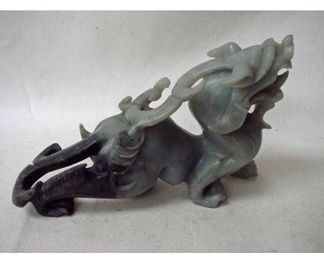 A Chinese carved jade sculpture depicting a mythical dragon dog and scorpion, 32cm 