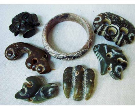 A collection of seven Chinese Hongshan jade/hardstone carved bangle and stylised devices 4.5cm to 8.5cm (7)