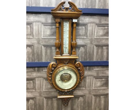 LATE VICTORIAN OAK WHEEL BAROMETER, with moulded swan neck pediment above a mercury thermometer flanked by two columns, the b