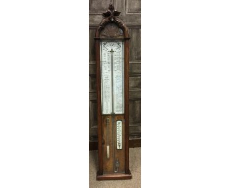 EARLY 20TH CENTURY ADMIRAL FITZROY WALNUT BAROMETER, with painted white dial, the arched top moulded with fleur-de-lis cresti