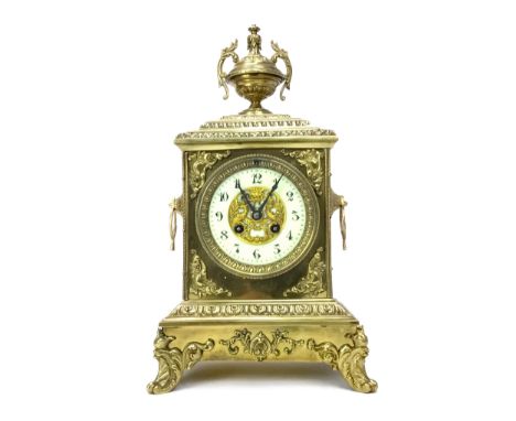 EARLY 20TH CENTURY GILT METAL MANTEL CLOCK, with two train movement, white enamel Arabic numeral chapter ring, the architectu