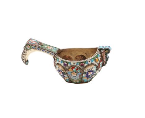 with corded borders, a lobed body, decorated with shaded polychrome enamel and cabachon bosses on the handle and below the ri