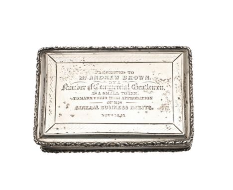 rectangular form, with reeded sides, an applied foliate scroll border, engine-turned decoration and a presentation inscriptio