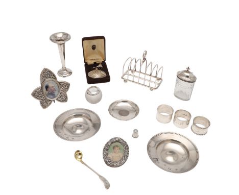 a toast rack, a glass mounted vesta ball, a thimble,  a vase (loaded base), two small photograph frames, three napkin rings (