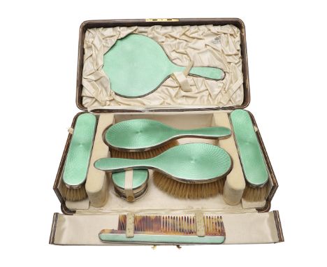 decorated with translucent green enamel on each piece, all contained in original fitted case with tooled initials,  by Goldsm