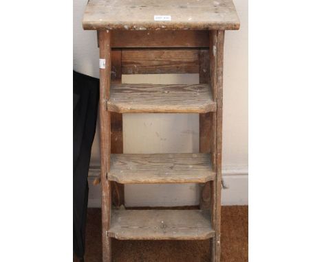 A small three-step set of vintage wooden ladders