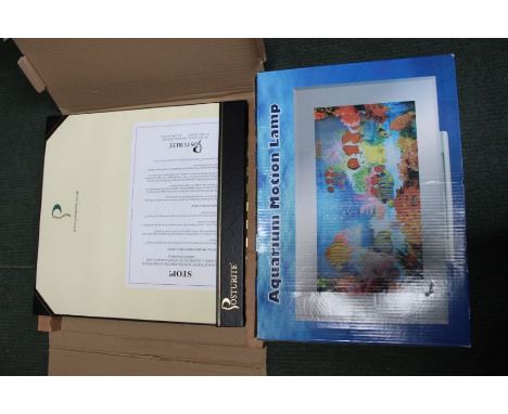 A boxed aquarium motion lamp together with a boxed Posturite spinal corrector