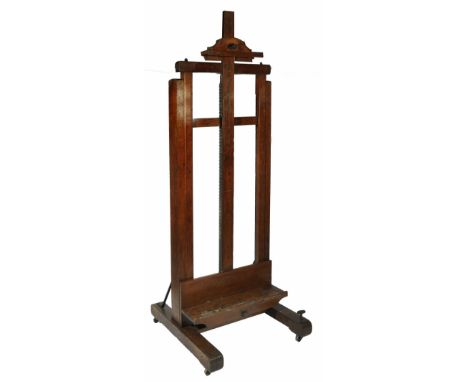 A LATE VICTORIAN ARTIST'S OAK STUDIO EASEL, the height adjustable rest operating by a turned and ebonised screw and with cran