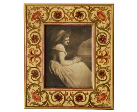 AN EDWARDIAN EASEL FRAME, the border painted with scrolling foliage in William Morris style on a cream ground, with label ver
