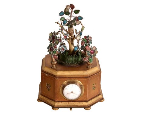 An unsual gilt metal, carved paste and polychrome painted singing bird...   An unsual gilt metal, carved paste and polychrome