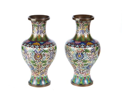 A PAIR OF EARLY 20TH CENTURY CHINESE CLOISONNE ENAMEL VASES with all over flower and leaf decoration, 13 ins high (one dented
