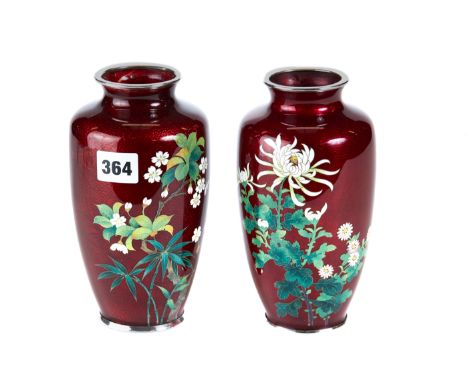 A PAIR OF JAPANESE RED GROUND CLOISONNE ENAMEL VASES decorated with flowers and leaves, each 7 1/2 ins high.    £50-£75