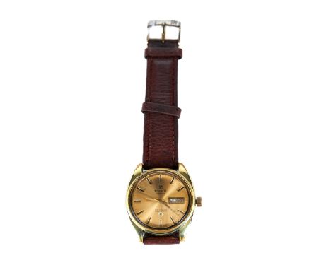 A GENTS TISSOT SEASTAR AUTOMATIC GOLD PLATED WRIST WATCH, champagne dial with day/date, on a leather strap.   £30-£50